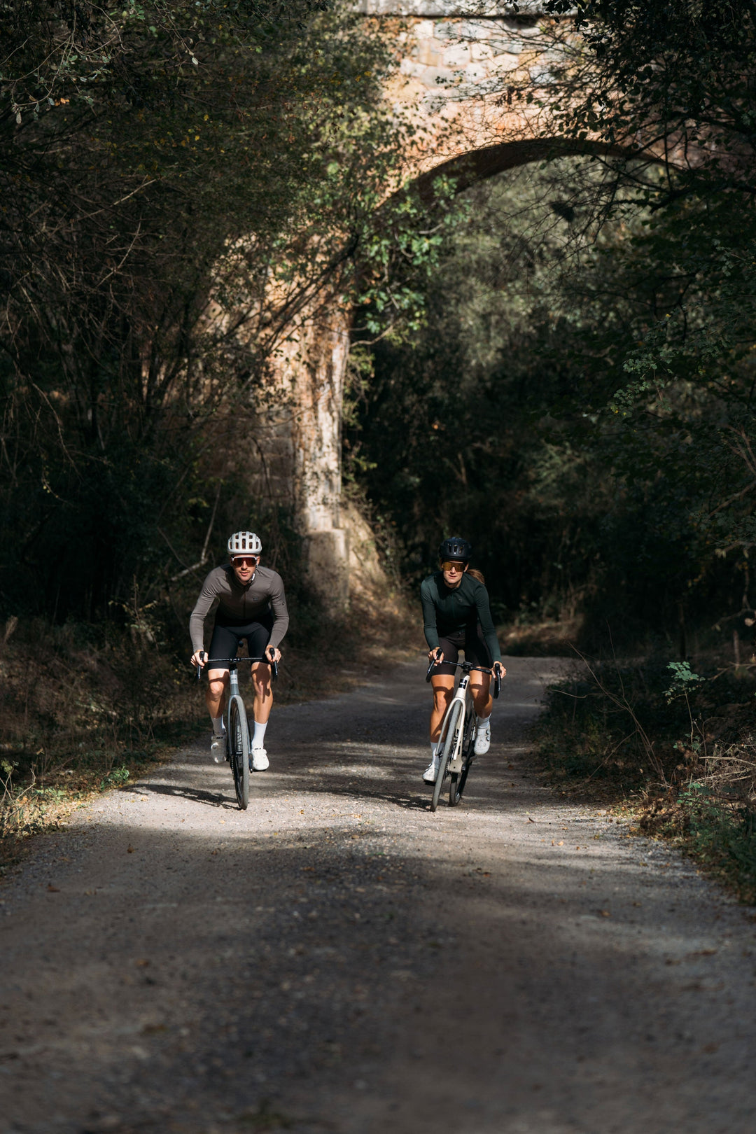 Two riders on a woodland road