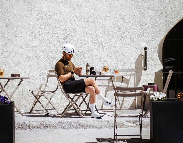 cyclist outside the cycle collective with coffee